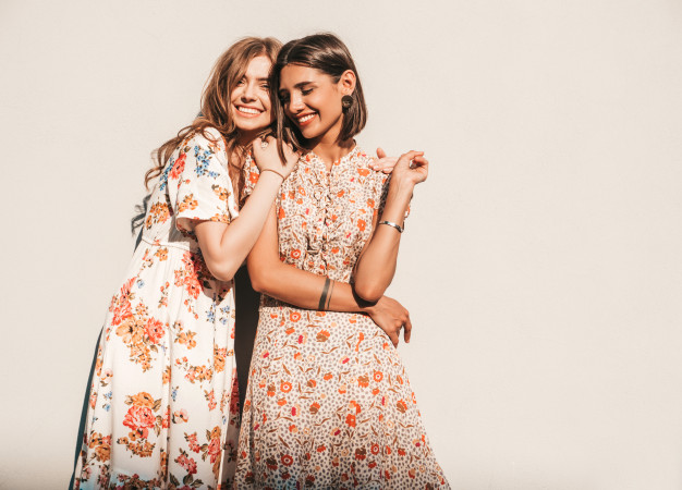 two-young-beautiful-smiling-hipster-girls-trendy-summer-sundresses_158538-16607